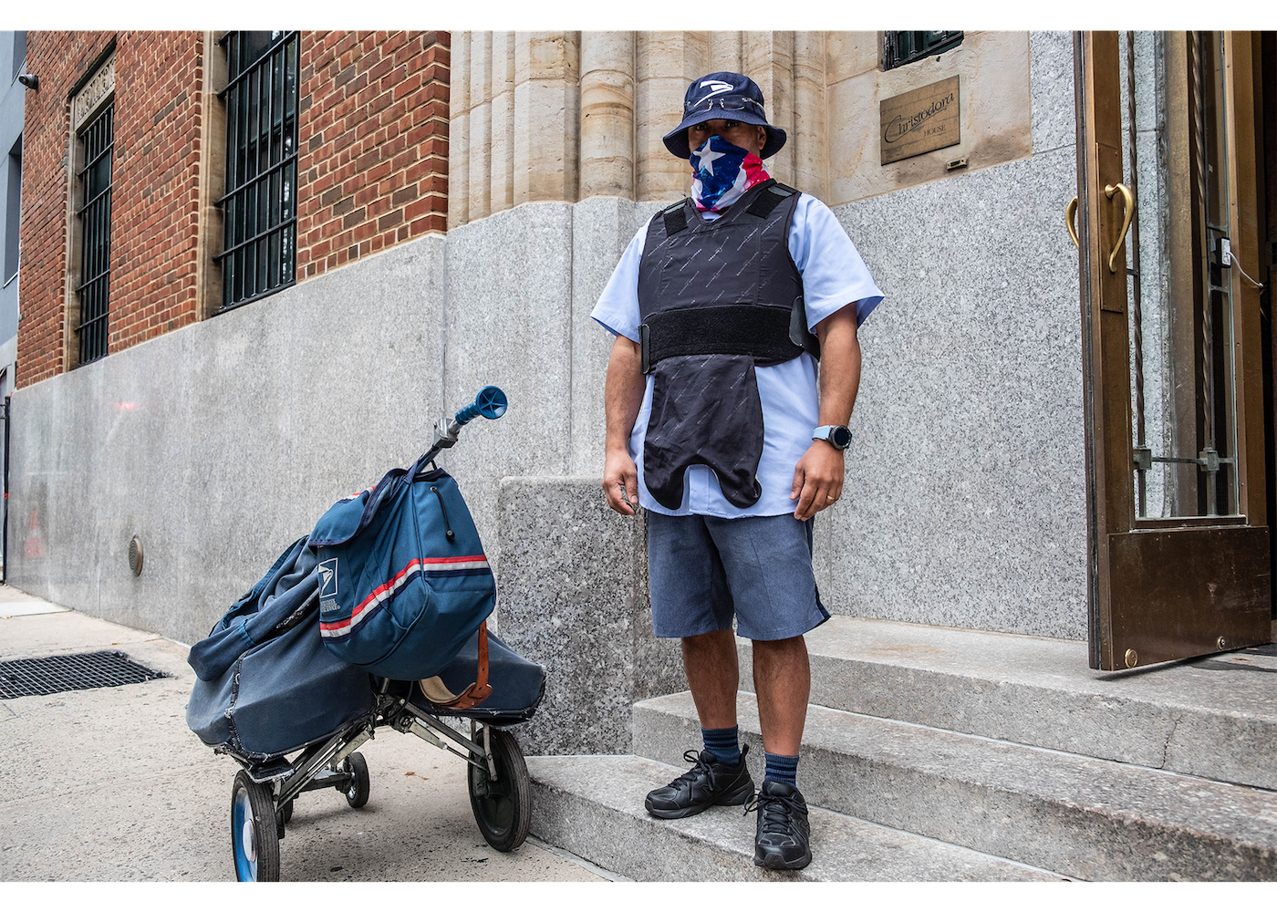 portrait of a mail person with bulletproof vest and mask